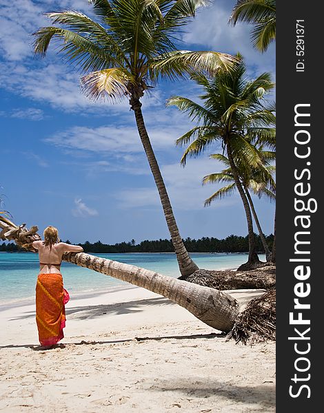 Girl and palm tree on the Bavaro Beach, Dominican republic