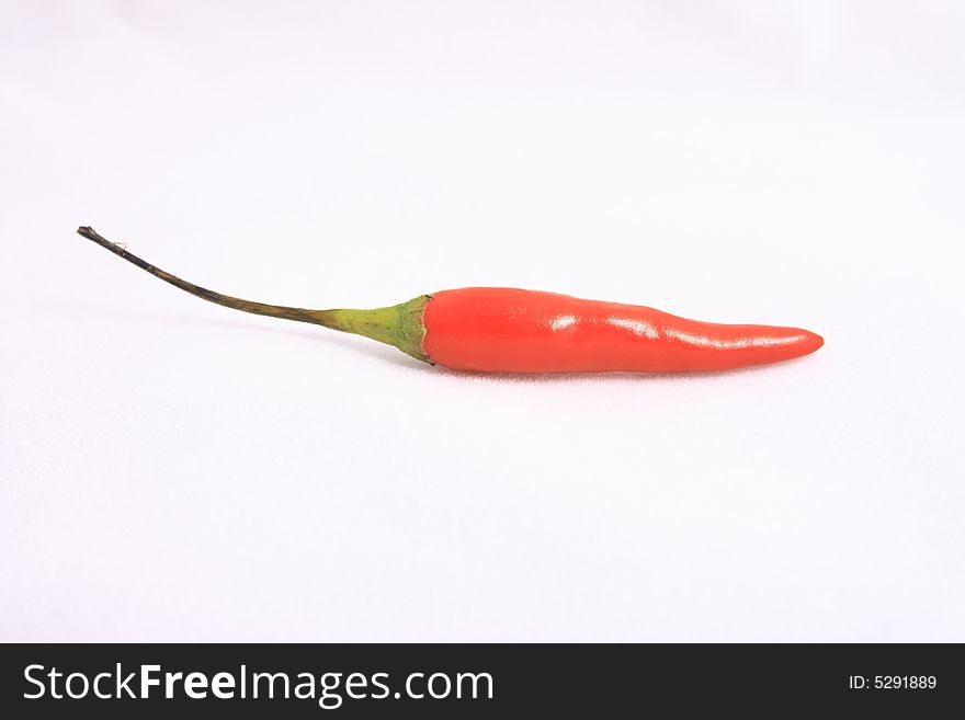 Little red pepper on a white background