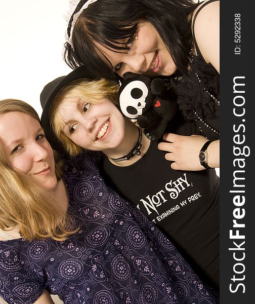 Three happy young girls on white background