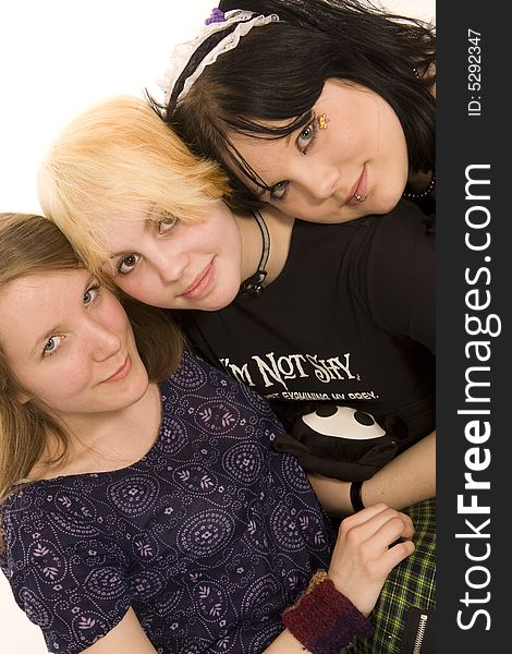 Three happy young girls on white background