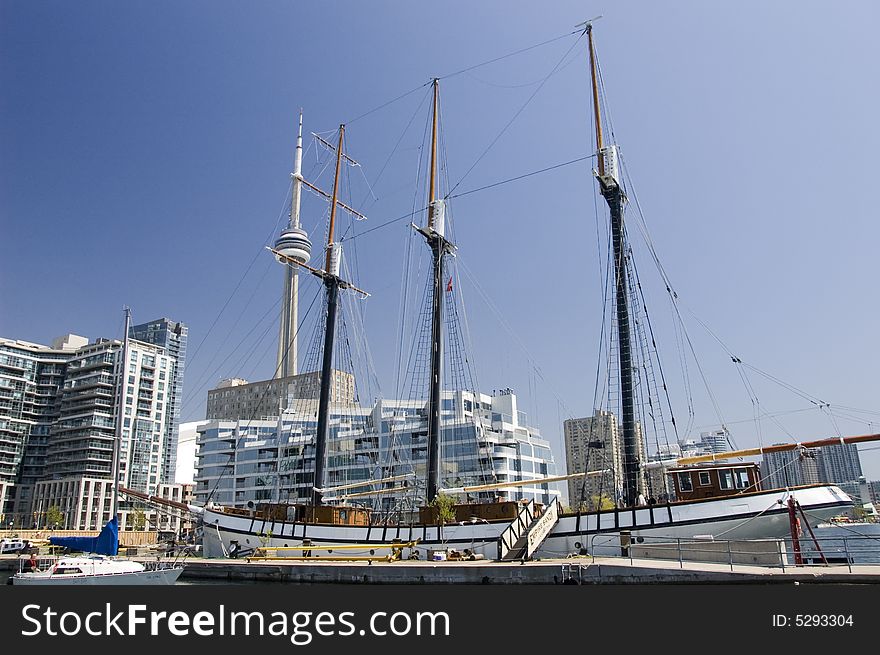 A marina at the lakeshore in city of Toronto and the CN Tower in the background. A marina at the lakeshore in city of Toronto and the CN Tower in the background