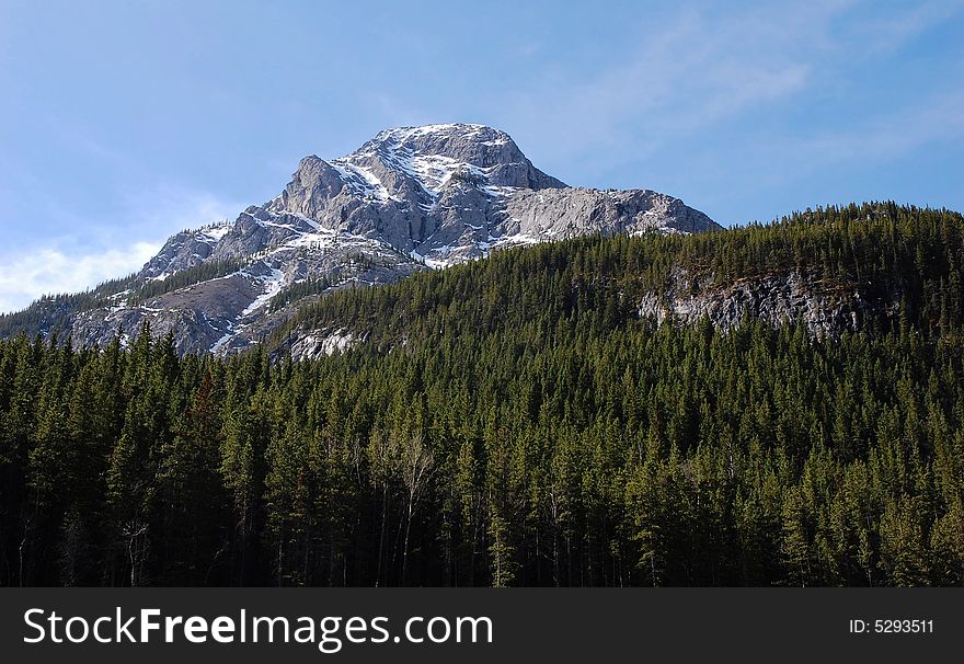 The peak of rocky mountain above forests in kananaskis country, alberta, canada. The peak of rocky mountain above forests in kananaskis country, alberta, canada