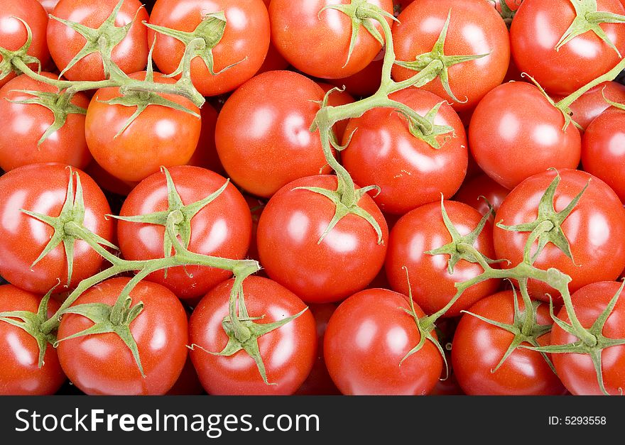 Frame filled with cherry tomatoes on green stems