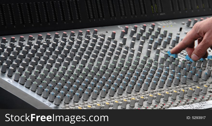 Hand on sound mixing console