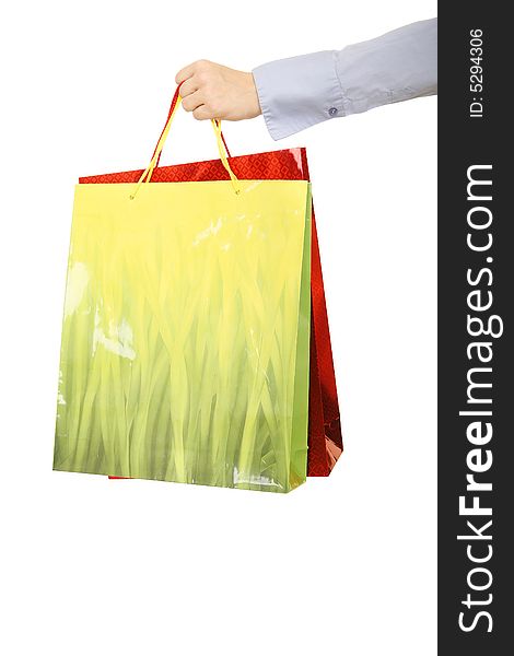 Isolated shot of hand of casual woman hand over bags of gift. concept for holiday or present. Isolated shot of hand of casual woman hand over bags of gift. concept for holiday or present