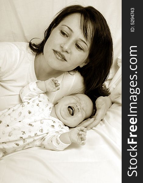 Mom and little baby girl over white background