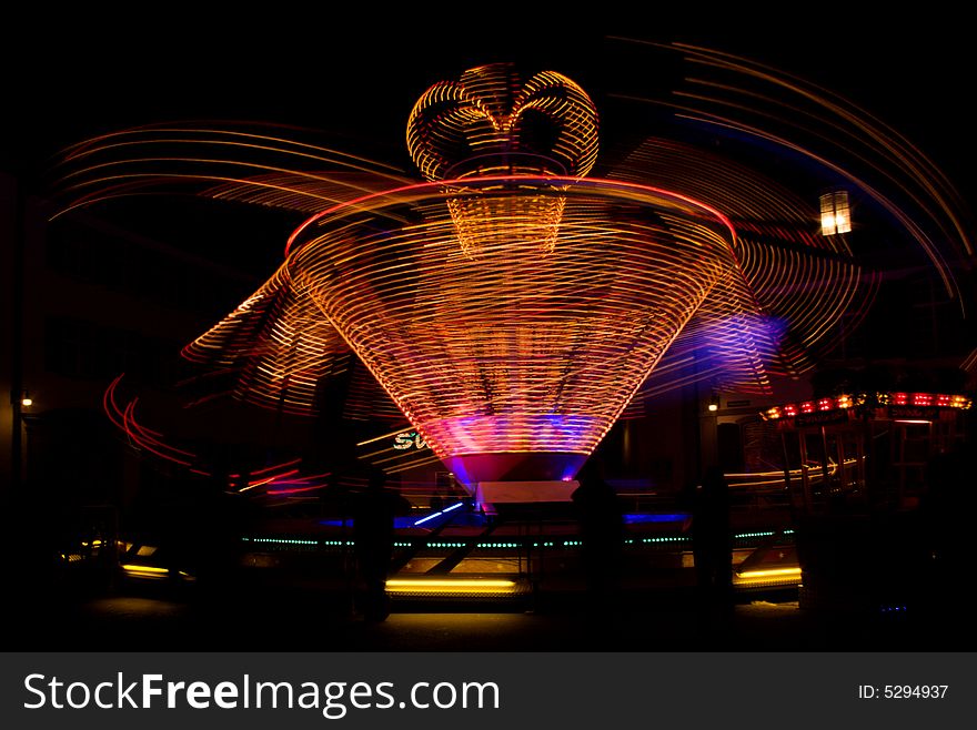 Night view at the carousel in the motion