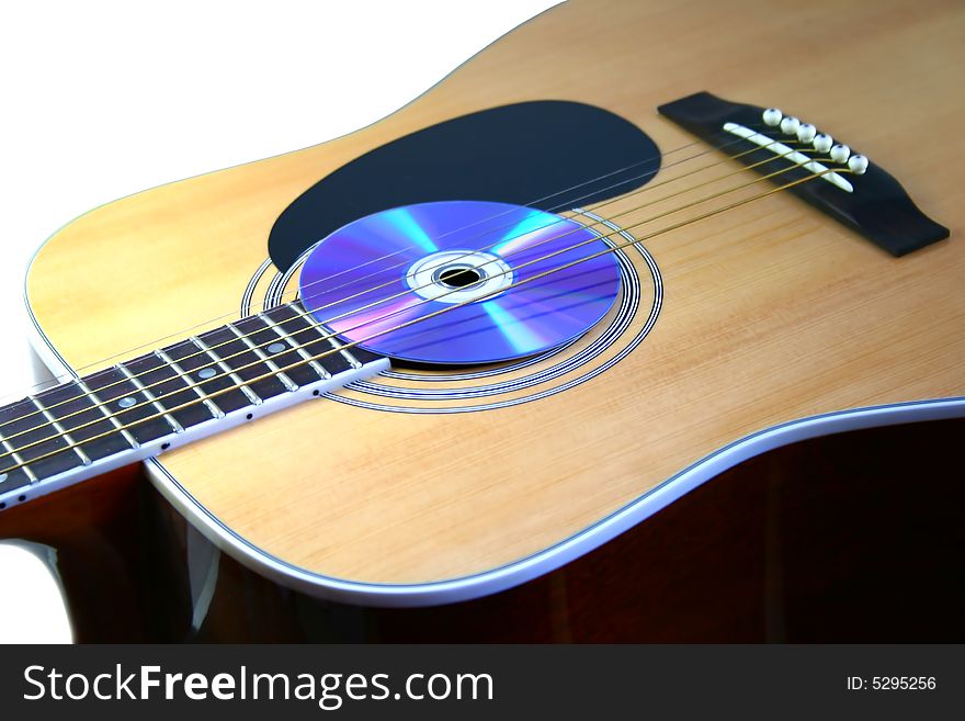 Guitar with audio disc on white background