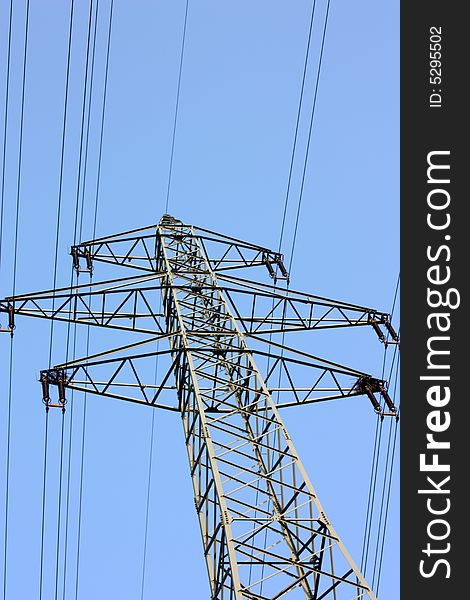 High voltage power line with a blue sky.