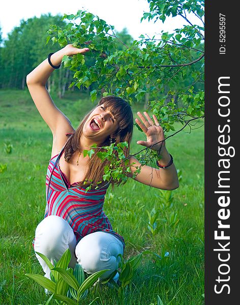 Young adult girl spend her time in nature with leaves of birch. Young adult girl spend her time in nature with leaves of birch