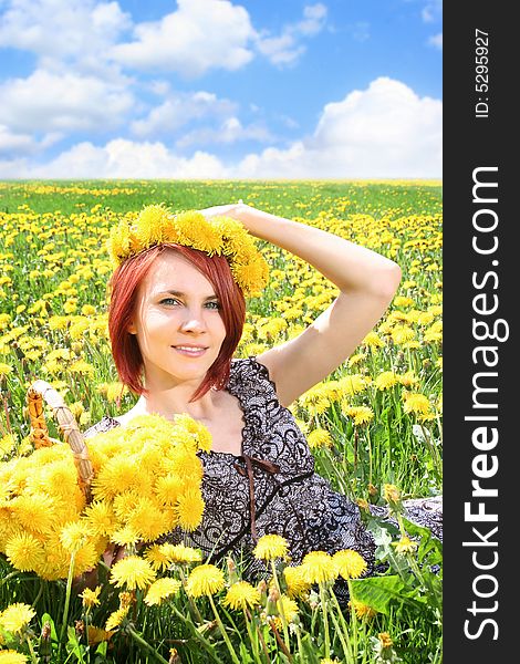 Beautiful redhead girl with basket of dandelions