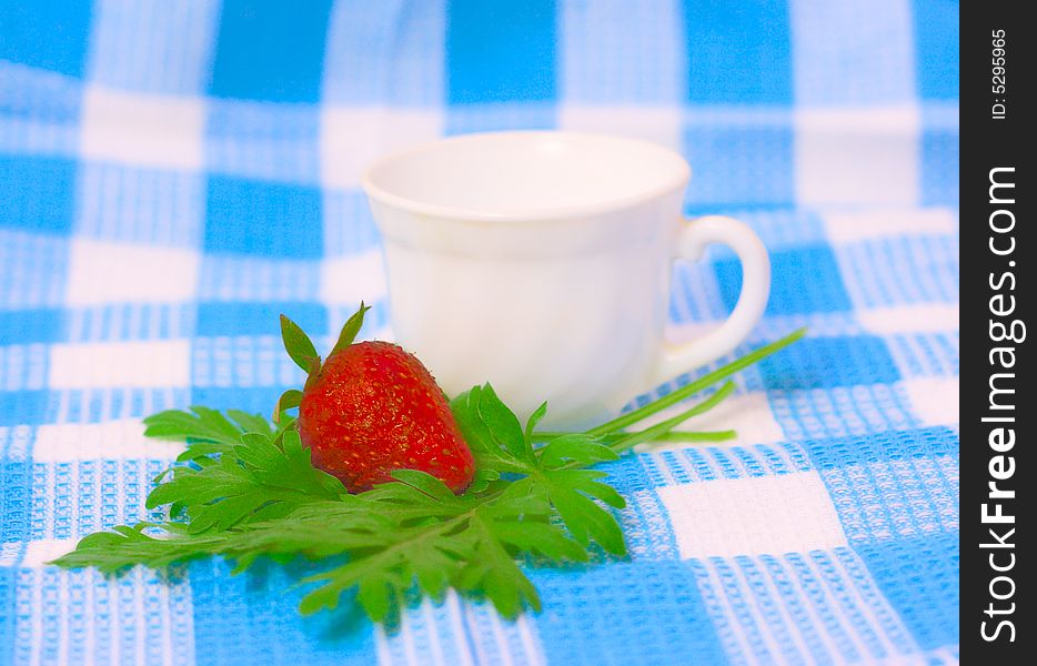 Strawberry And Cup On Fabric Background
