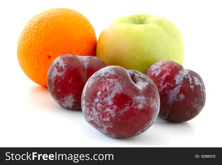 Apple, orange and  three lilac  plums on overwhite background. Apple, orange and  three lilac  plums on overwhite background.