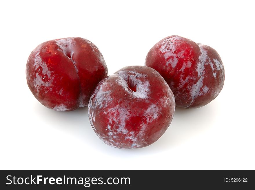 Three juicy lilac plums on overwhite background. Three juicy lilac plums on overwhite background.