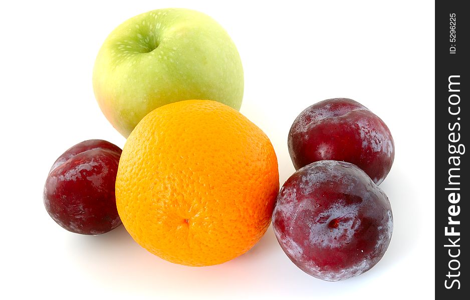 Apple, orange and  three lilac  plums on overwhite background. Apple, orange and  three lilac  plums on overwhite background.