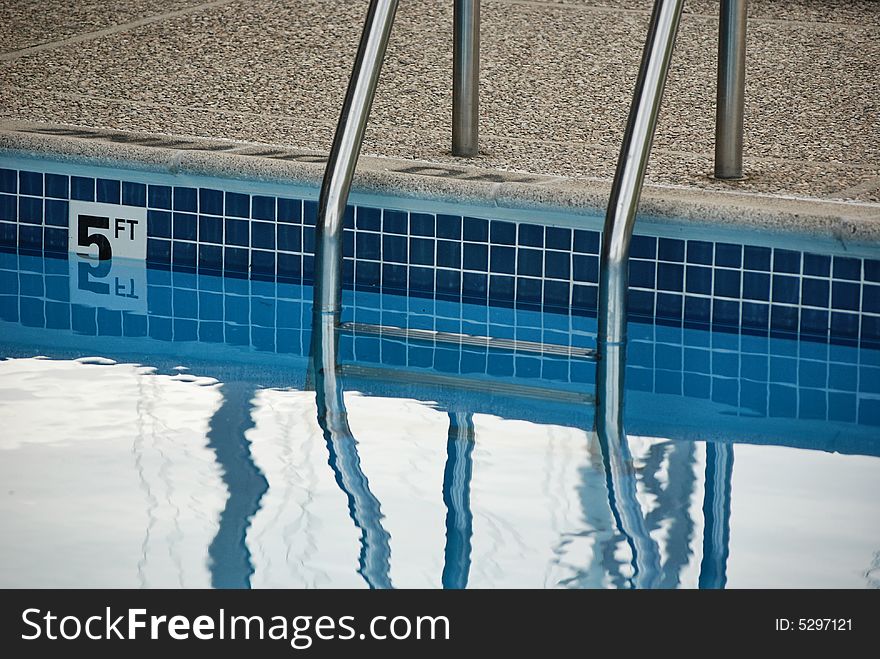 Aluminum ladder at the deep end of the swimming pool. Aluminum ladder at the deep end of the swimming pool.