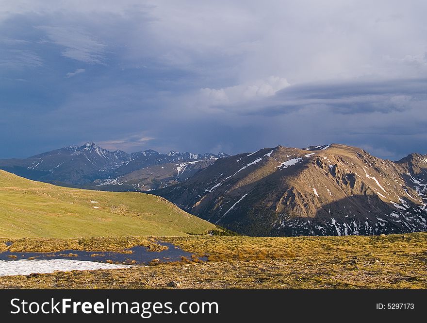 Rain over Trail Ridge in Rocky Mountain National Park.  Stones Mtn. in the foreground and Longs Peak in the distance ..