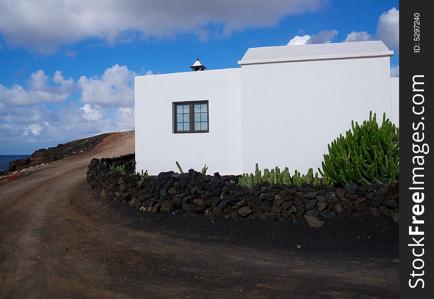 White oriental stile hous on the sea shore with cactus garden in front. White oriental stile hous on the sea shore with cactus garden in front