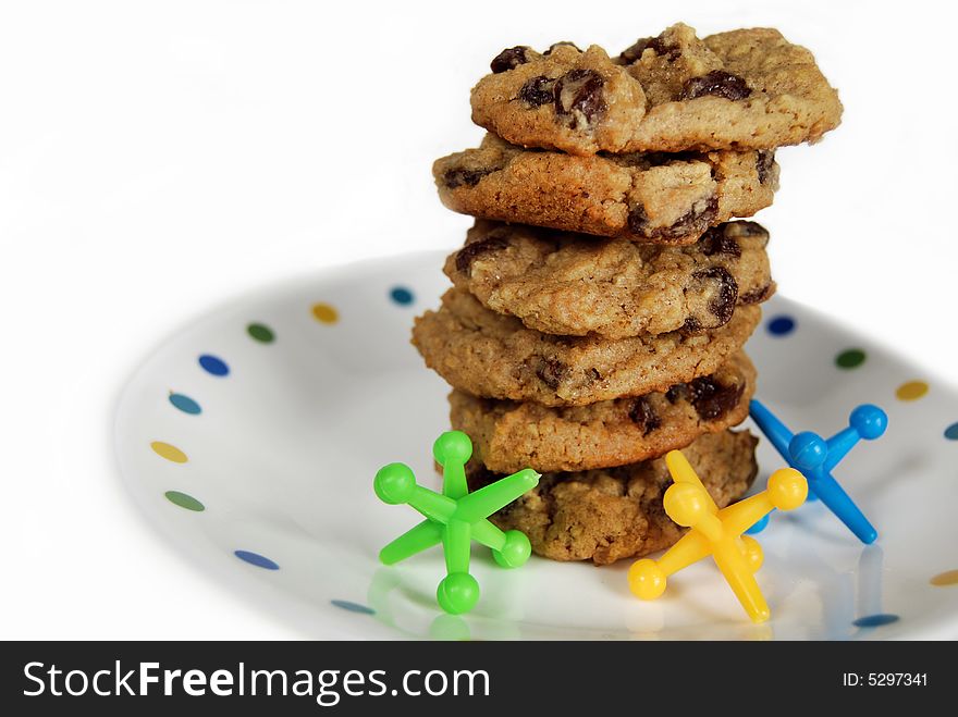 Stack of oatmeal raisin cookies with toy jacks. Stack of oatmeal raisin cookies with toy jacks.