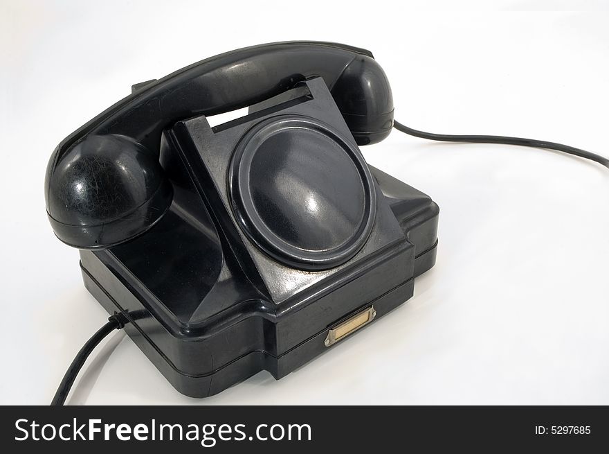 The old telephone of black colour on a white background. The old telephone of black colour on a white background.