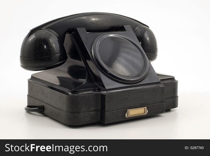 Old-fashioned black telephone receiver with cord on white background. Old-fashioned black telephone receiver with cord on white background.