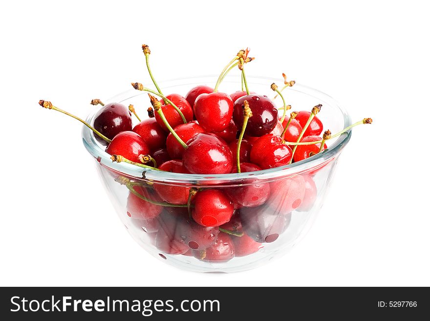 An image of ripe red cherries in a glass cup