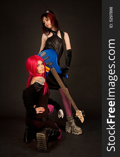 Two girls with guitar smoking, isolated in studio. Two girls with guitar smoking, isolated in studio