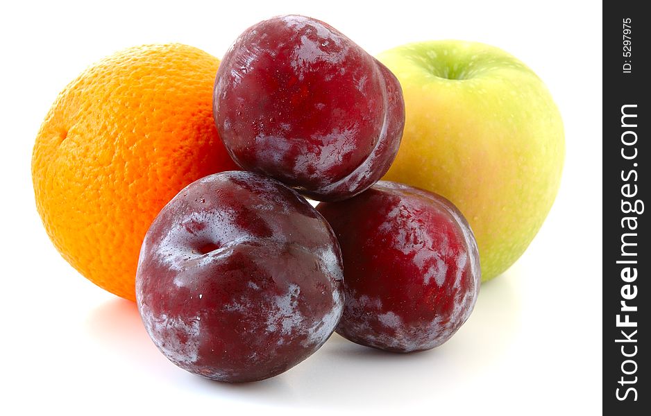 Apple, orange and  three lilac  plums on overwhite background. Apple, orange and  three lilac  plums on overwhite background.