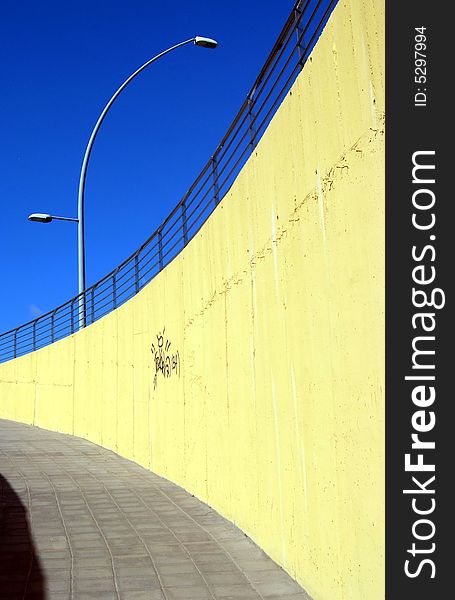 Colourful subway street scene with blue sky, a lamppost and graffiti on the wall. Colourful subway street scene with blue sky, a lamppost and graffiti on the wall