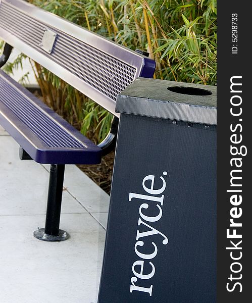Purple park bench and a black recycle box. Purple park bench and a black recycle box