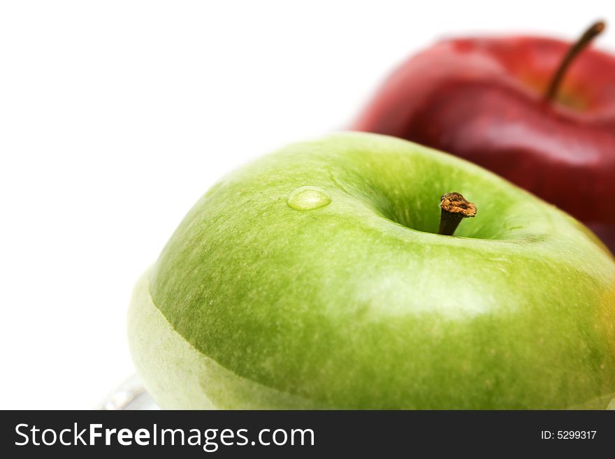 Green and red apples in water, isolated