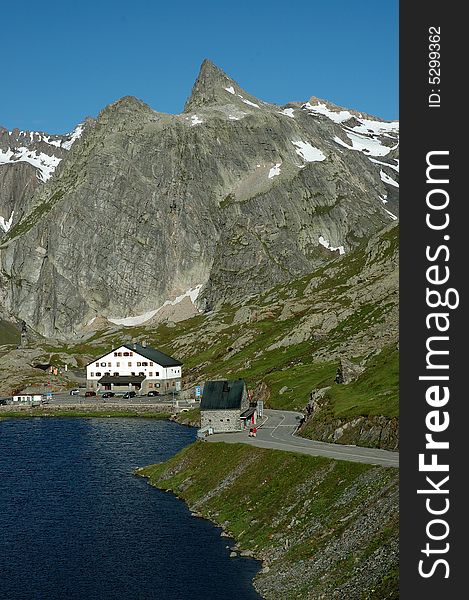 Early in the morning, landscape view of the lake and mountains at the Grand-Saint-Bernard pass between Italy and Switzerland. The picture shot from Switzerland shows the Italian side of the border. Early in the morning, landscape view of the lake and mountains at the Grand-Saint-Bernard pass between Italy and Switzerland. The picture shot from Switzerland shows the Italian side of the border.