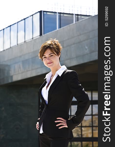 Smiling businesswoman against urban background. Smiling businesswoman against urban background.