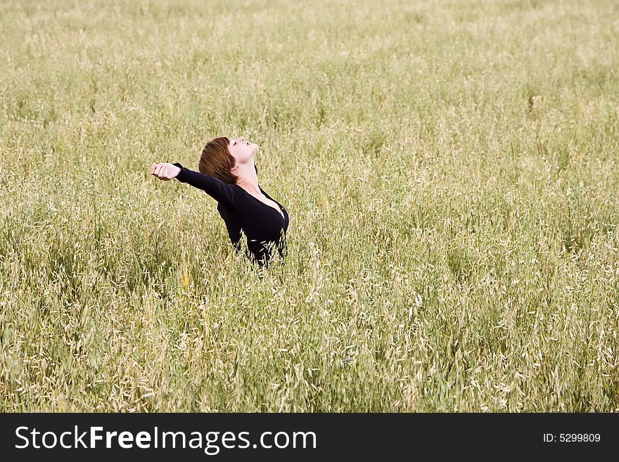 Woman feeling freedom in a field. Woman feeling freedom in a field.