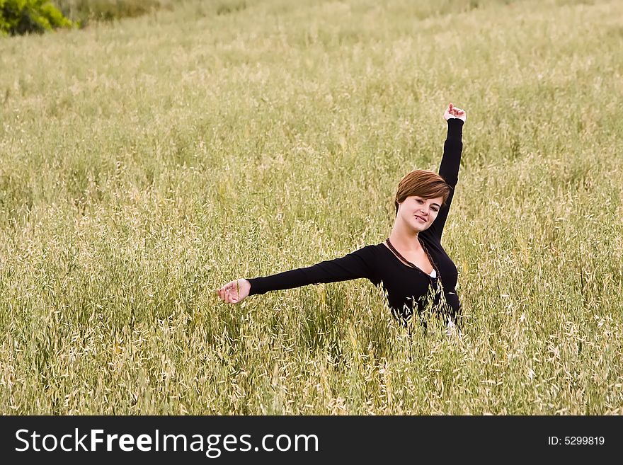 Woman feeling freedom in a field. Woman feeling freedom in a field.