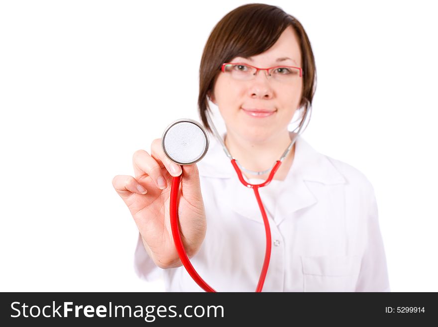 Young female doctor isolated on white, with red stethoscope in focus, person is blurred. Young female doctor isolated on white, with red stethoscope in focus, person is blurred