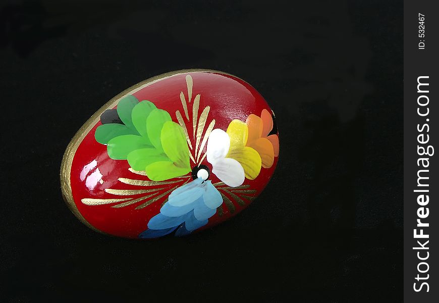 Painted easter egg over black background