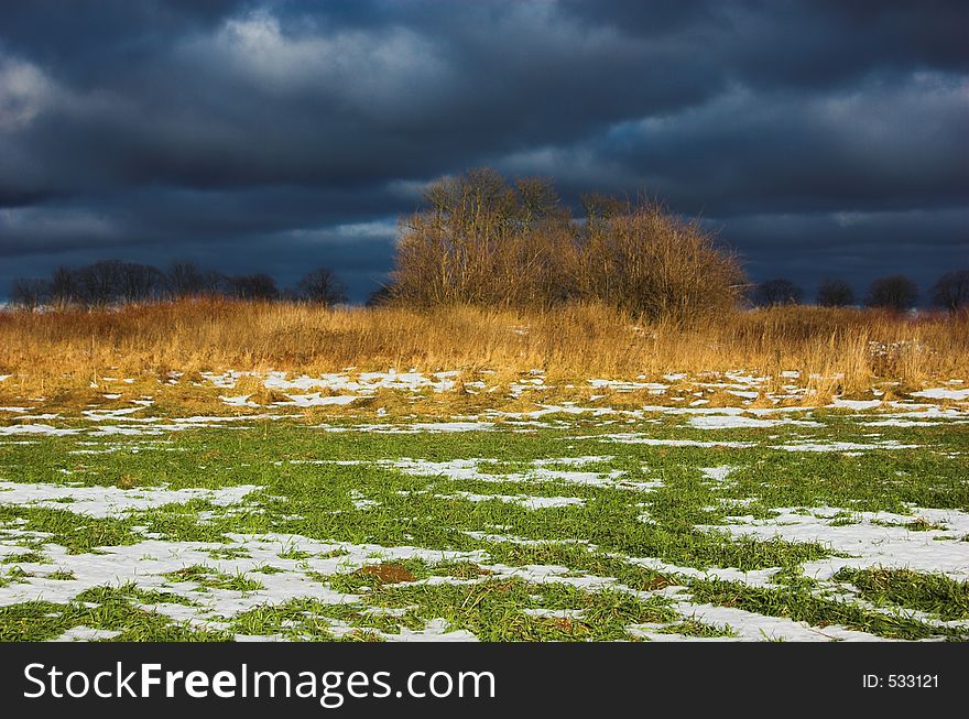 Winter - spring snowy meadow before the storm. Winter - spring snowy meadow before the storm