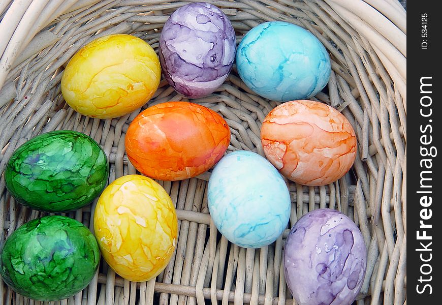 Colored eggs in easter basket