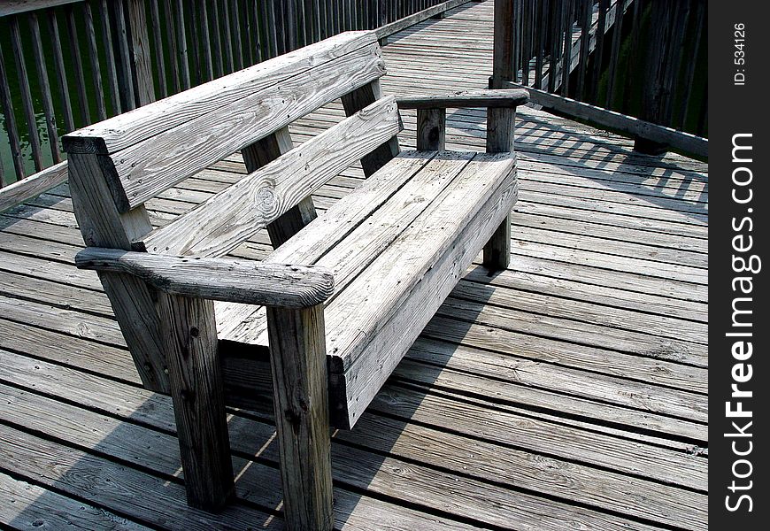 Wooden bench on a wooden boardwalk. Wooden bench on a wooden boardwalk