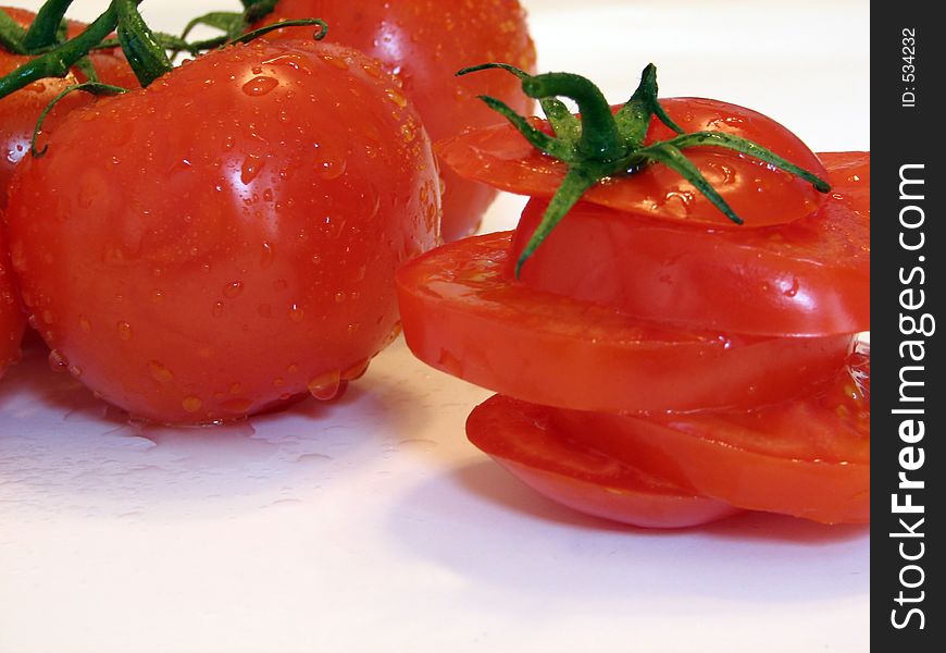 Shot of a few tomatoes over white.