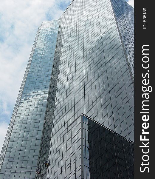 A skyscraper downtown with window washers. A skyscraper downtown with window washers