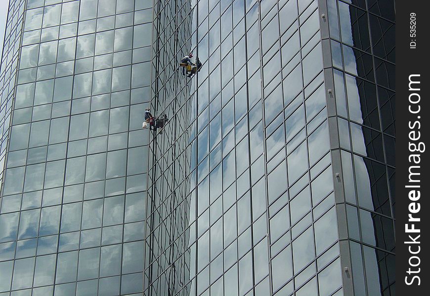 Window washers on a skyscraper. Window washers on a skyscraper