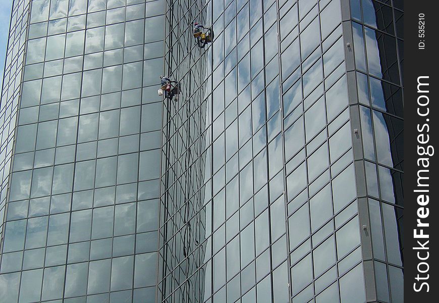 Window washers on a skyscraper. Window washers on a skyscraper