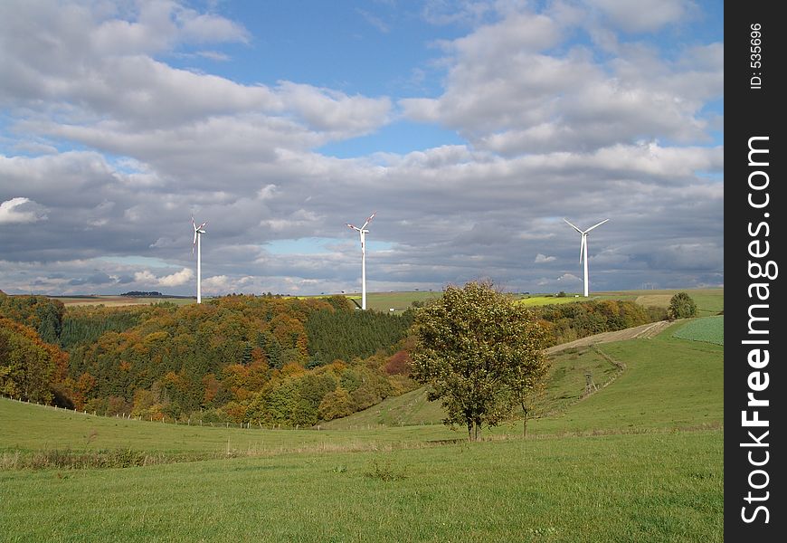 Three windpower stations on a hill in the high plain area of the Palatinate in Germany in autumn