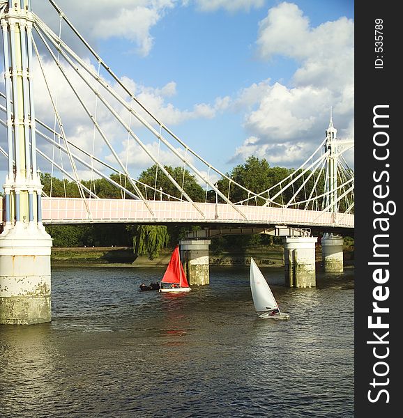 Small boats under Albert Bridge in London. Small boats under Albert Bridge in London