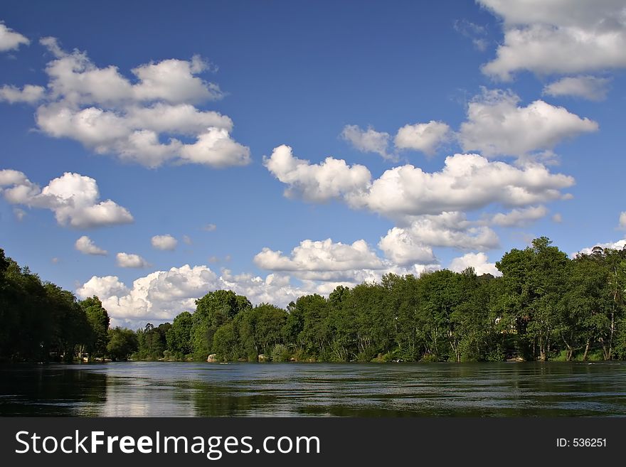 River and trees with blue sky