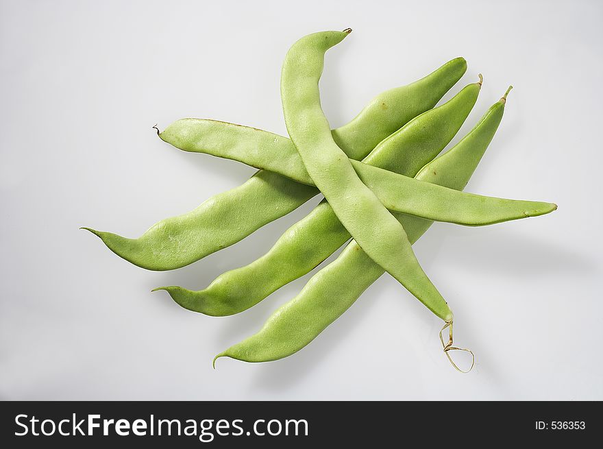 Five pole beans on white background - fuenf Fisolen auf weissem Hintergrund. Five pole beans on white background - fuenf Fisolen auf weissem Hintergrund