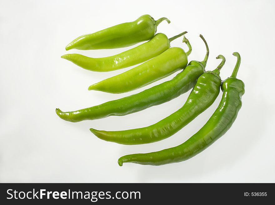 Six peppers in a row on white background - sechs Paprika auf weissem Hintergrund. Six peppers in a row on white background - sechs Paprika auf weissem Hintergrund