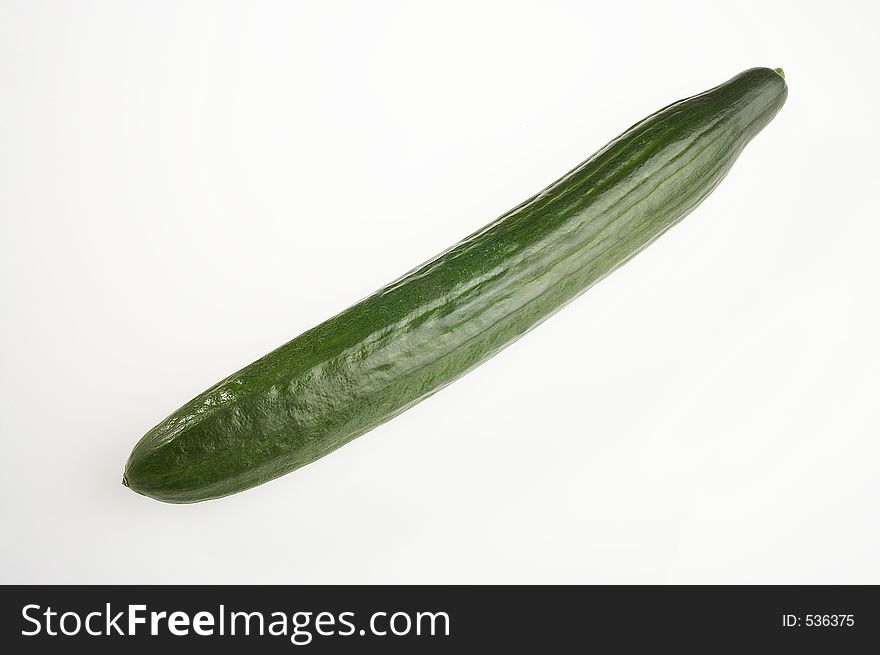 Long green cucumber on white background - lange gruene Gurke auf weissem Hintergrund. Long green cucumber on white background - lange gruene Gurke auf weissem Hintergrund